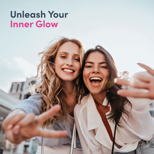 Two women taking a selfie with text 'Unleash Your Inner Glow' on a blurred cityscape background