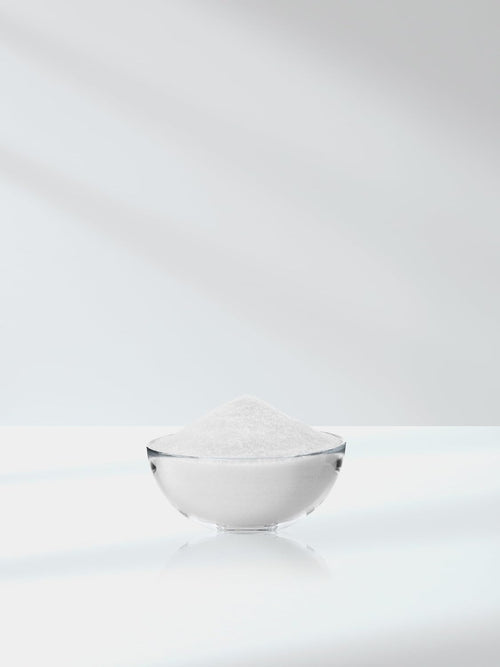 White bowl filled with white powder on a white background