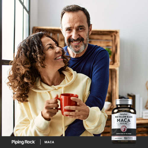 Man and woman hugging, woman holding a red mug, with a bottle of Piping Rock Maca supplement in the foreground.
