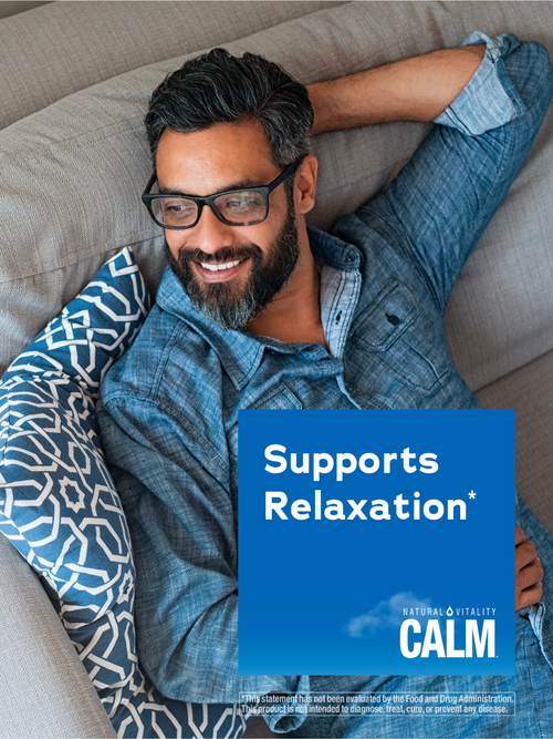 Man relaxing on a couch with a 'Supports Relaxation' sign featuring the brand 'CALM'.